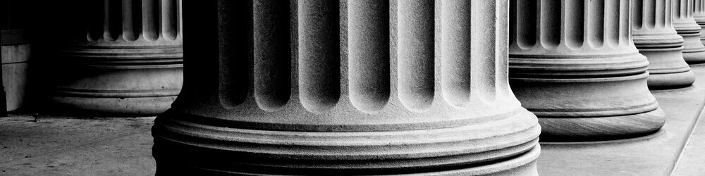 Picture of the base of large stone fluted columns.