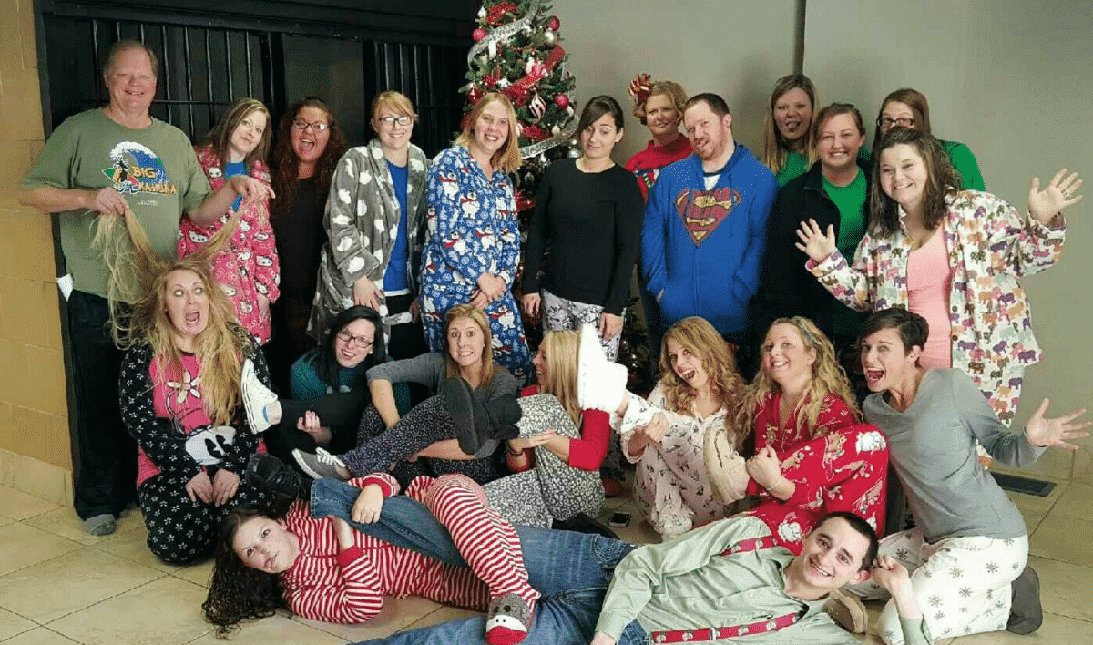 Mike Woods, one of the founders of Woods and Woods, The Veteran's Firm, and staff celebrating pajama day. 