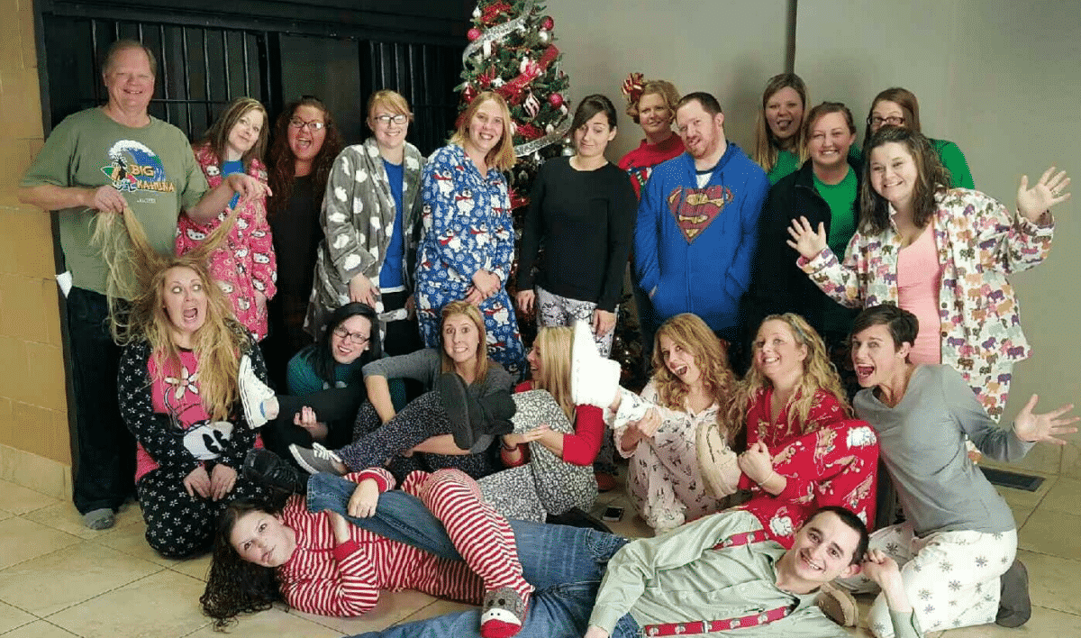 Mike Woods, one of the founders of Woods and Woods, The Veteran's Firm, and staff celebrating pajama day.