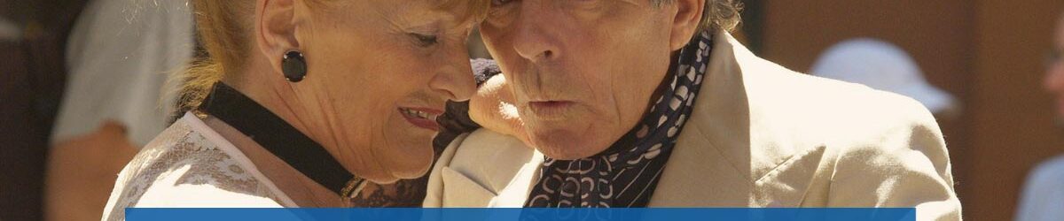 Picture of an older man and woman dressed up and dancing together outside. Our title is at the bottom: Disabled Veterans May Also Receive In-home Healthcare