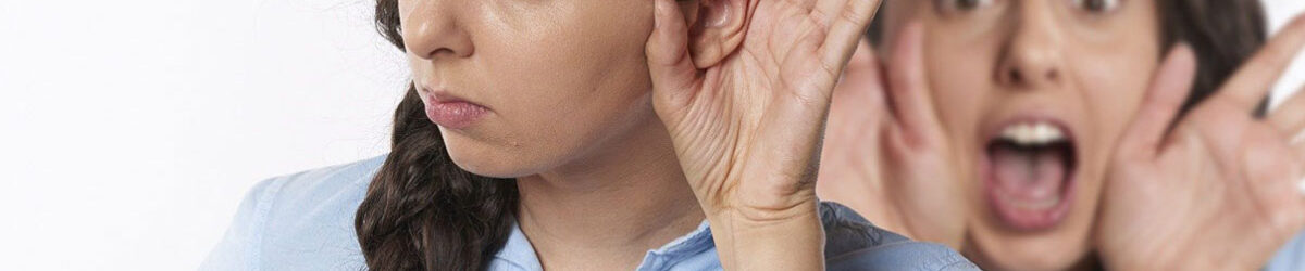 Picture of a woman doubled in the image. One of her is holding her hand on her ear like she can't hear, the other is a copy of her in the background screaming. Our title is out in front: PTSD and Tinnitus Go Together for Many Veterans